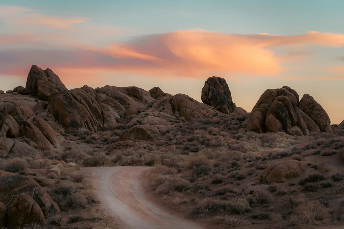 Desert rocks against sunset-lit clouds