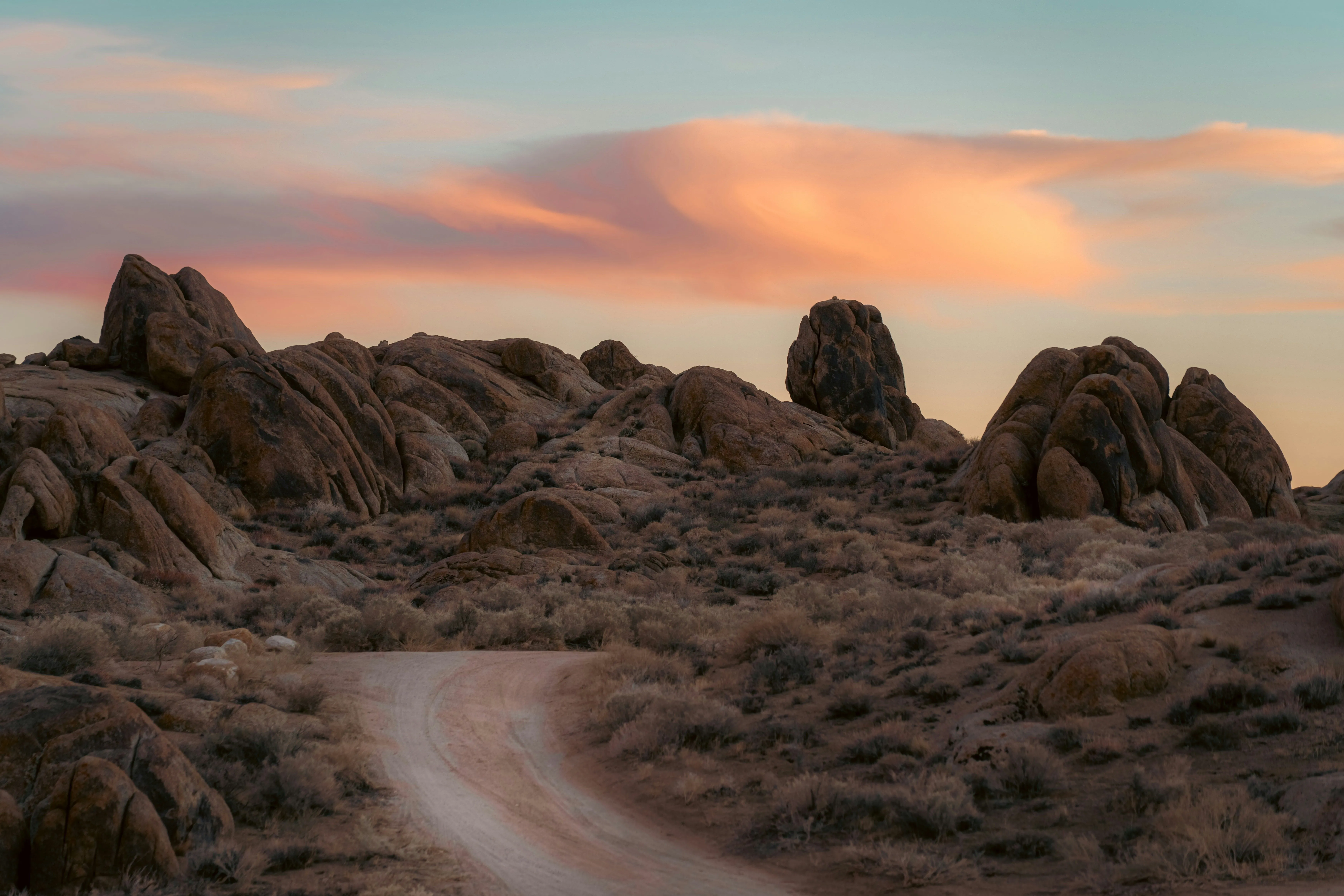 Desert rocks against sunset-lit clouds