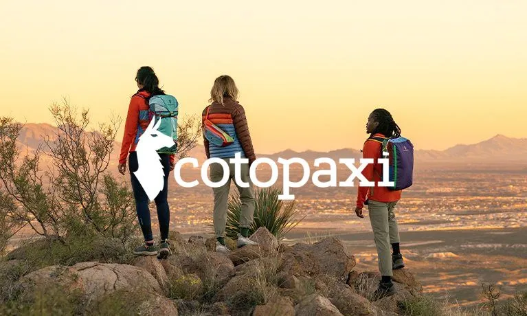 People standing near mountains during sunset.