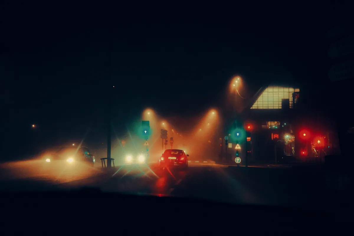 Nighttime street scene with cars
